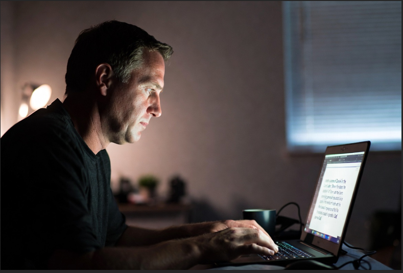 Man typing prompt to create Daniel in the lion's den scene